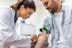 Phlebotomist Drawing Blood From a Patient